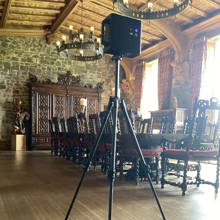 Virtual tour capture setup at Killua Castle featuring the grand dining hall with ornate wooden furniture, stone walls, and elegant chandeliers.