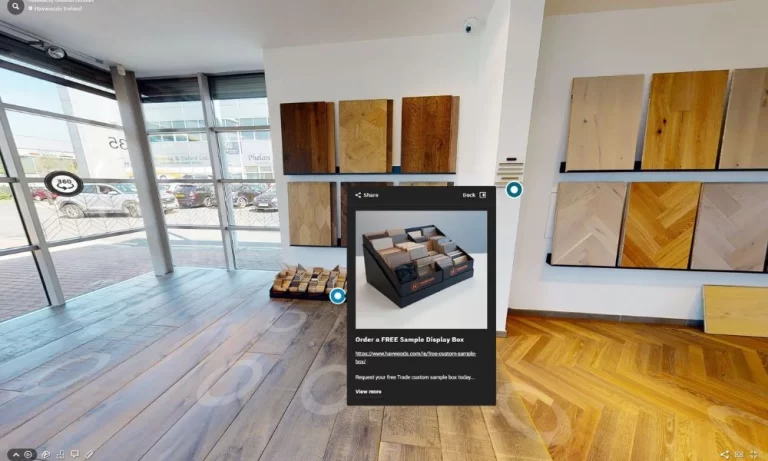Interactive virtual tour of a retail showroom with wood flooring samples on display, offering an option to order a free custom sample box through an embedded link.