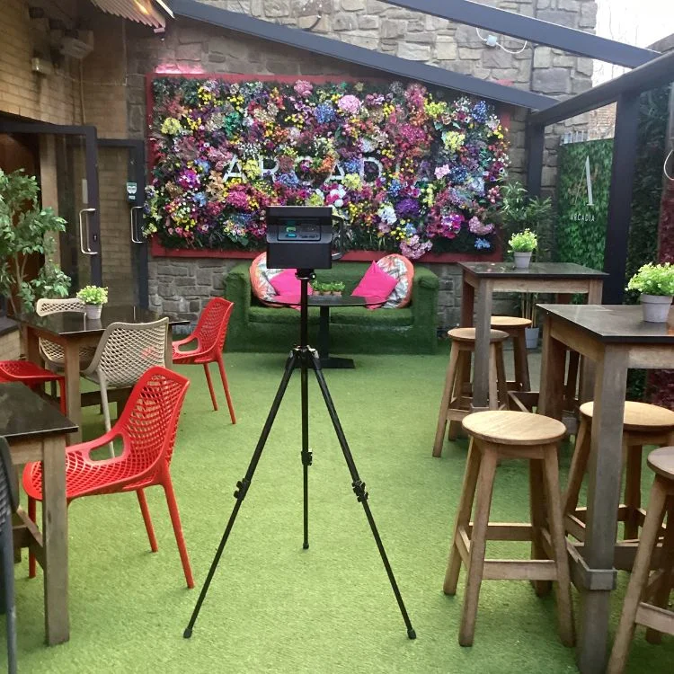 Matterport camera capturing the outdoor garden space of Arcadia Dublin with vibrant floral walls and colourful seating.
