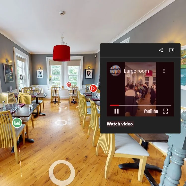 3D Virtual Tour of I Monelli showcasing the elegant large dining room with bright decor, wooden floors, and a featured video interaction.